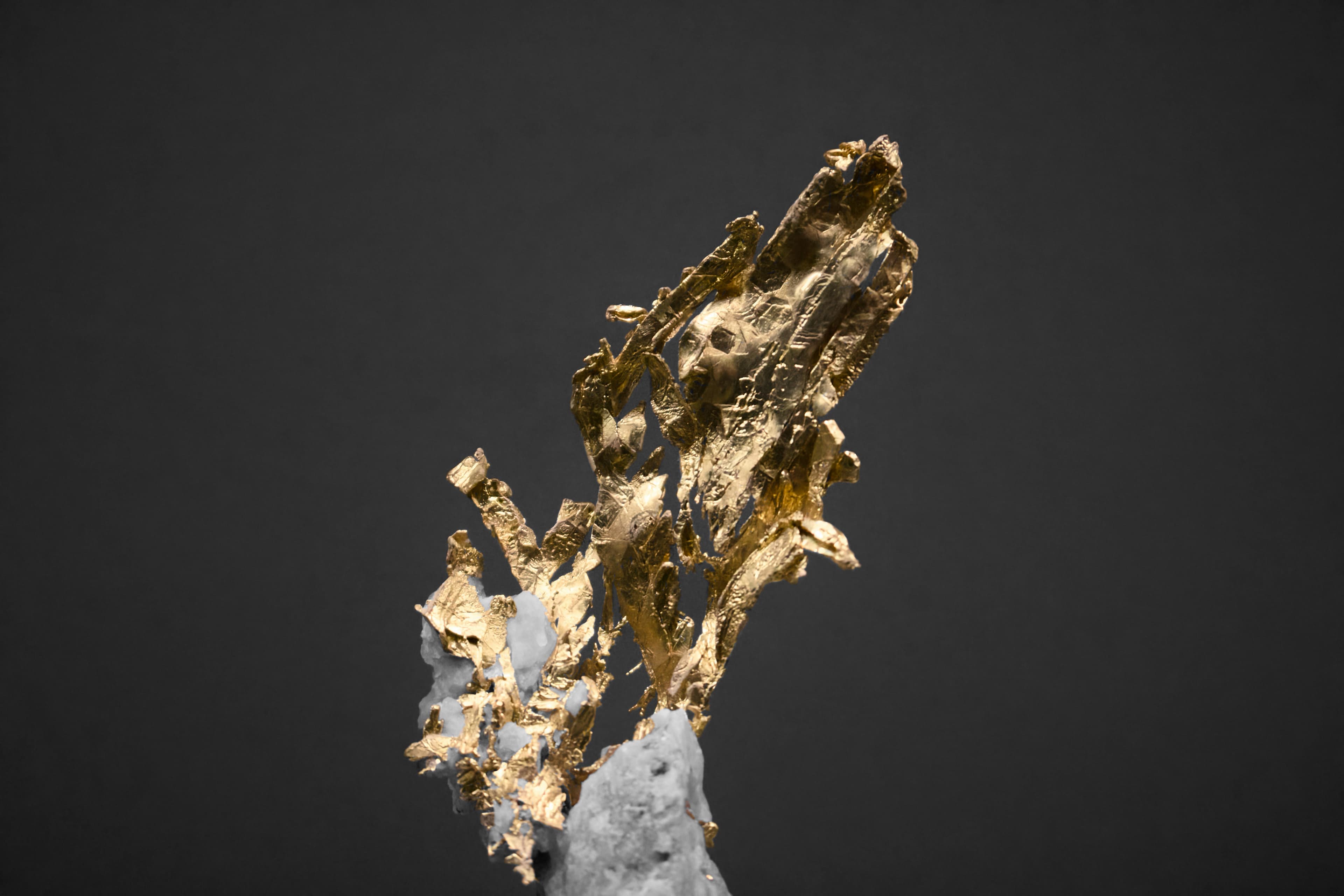 Refined gold bars stacked under warm directional light catching the stamped edges