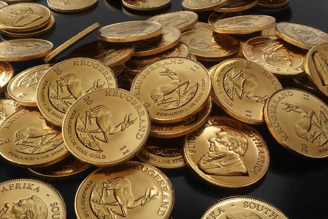 Pile of gold Krugerrand coins showing springbok and Paul Kruger faces