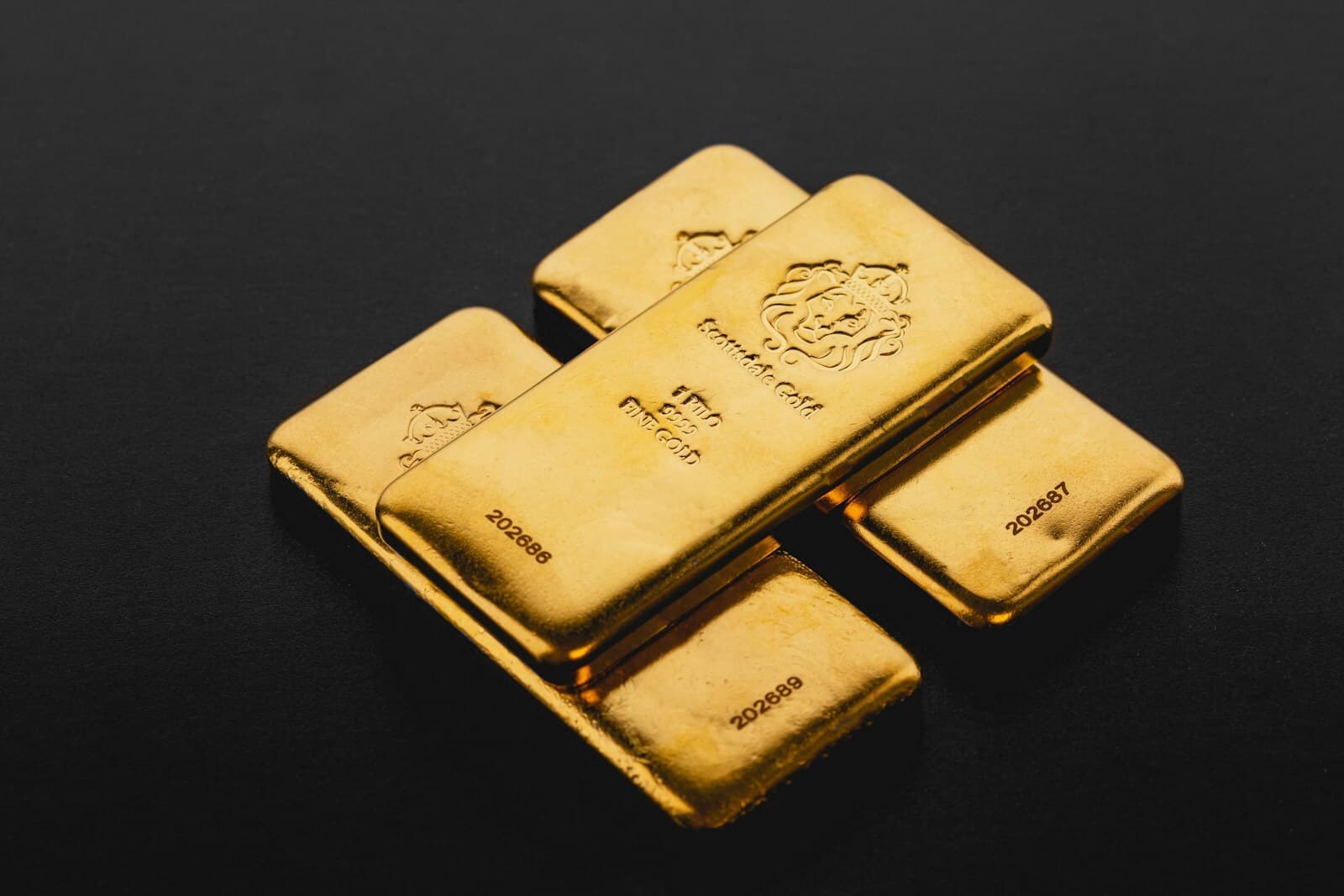 Single sovereign gold bar with stamped seal and warm amber edge lighting